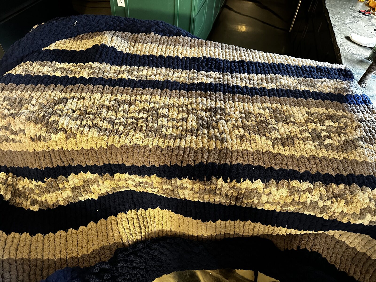 Navy, cream, and tan striped chunky knit blanket