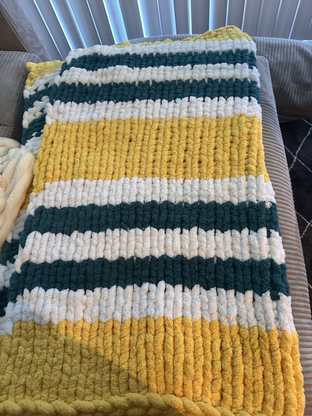 Green, gold, and cream striped chunky knit blanket
